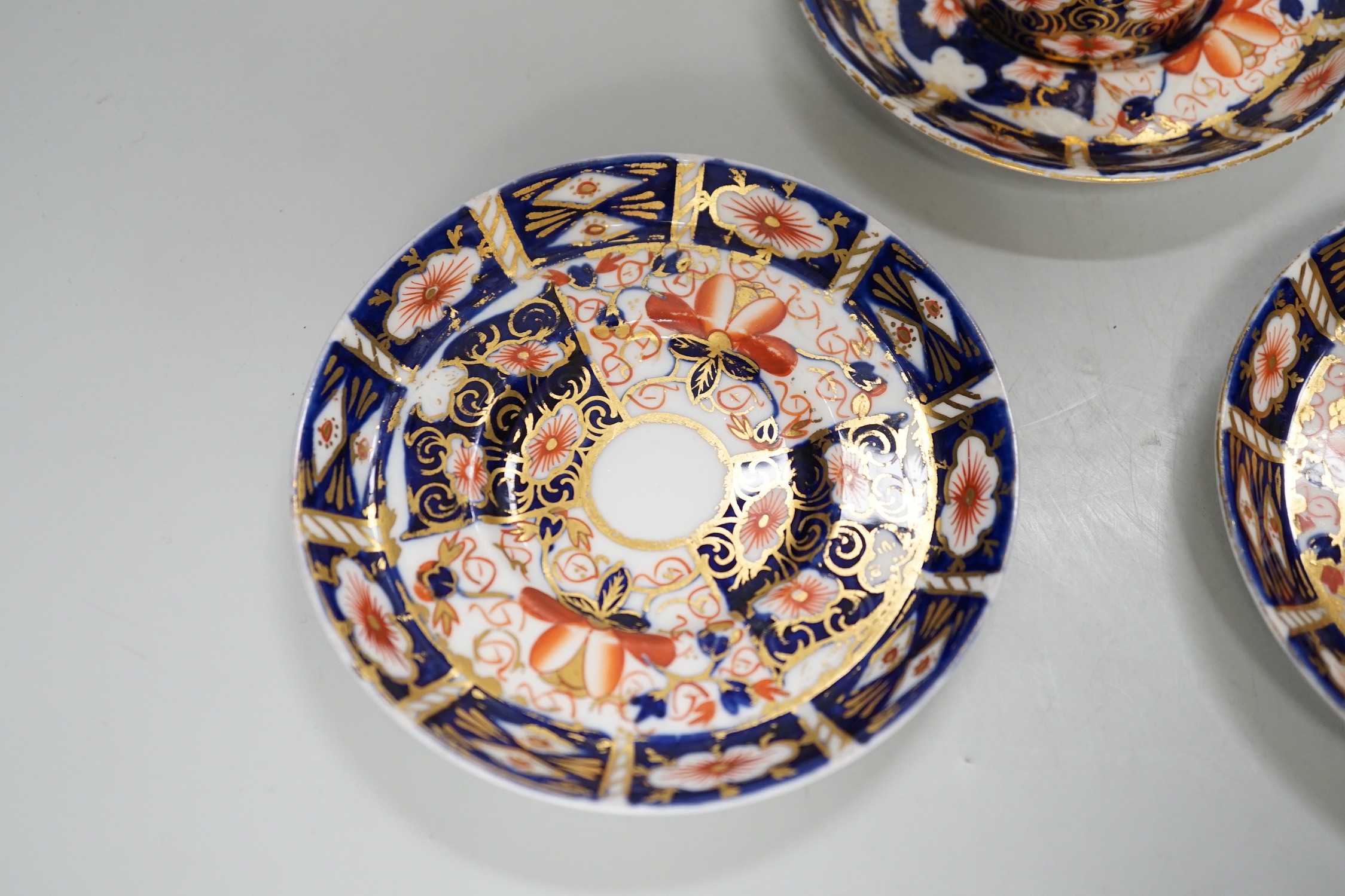 Five Royal Crown Derby Imari coffee cans and saucers